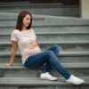 Woman sitting in maternity jeans and nursing top